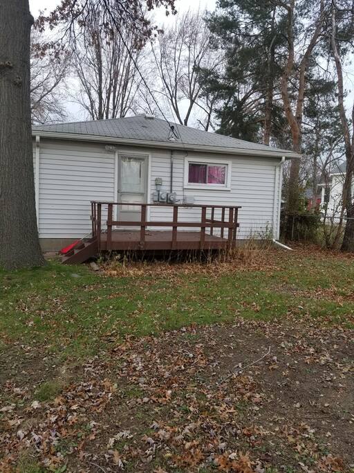 backyard with deck for relaxing in spring/summer. usually set up with chairs and tables, lights, fire pit, bug lanterns.