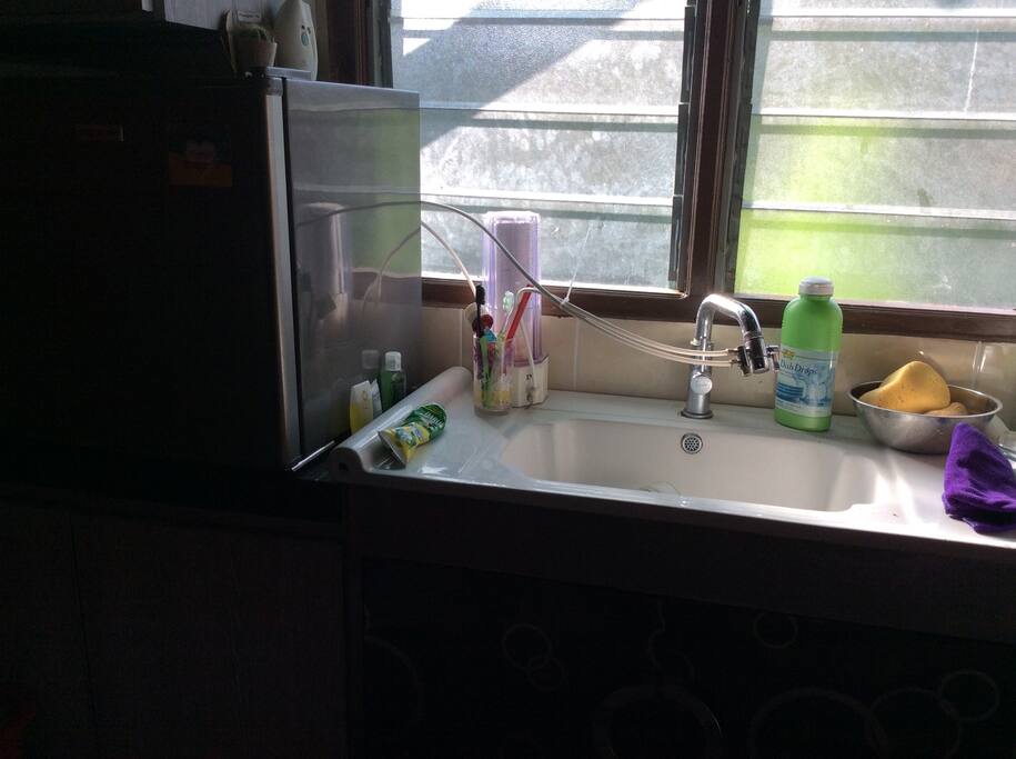 Kitchen space and small refrigerator.