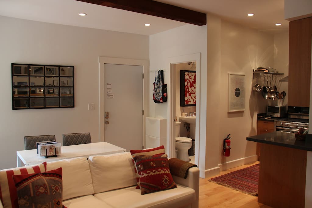 Open floor plan with wood floors and wool rugs throughout. High ceilings add to the bright & modern feel.