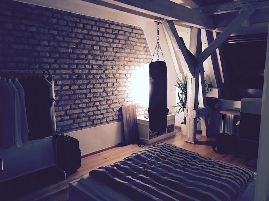 Your private room - chilled with a stylish stone wall and punching bag