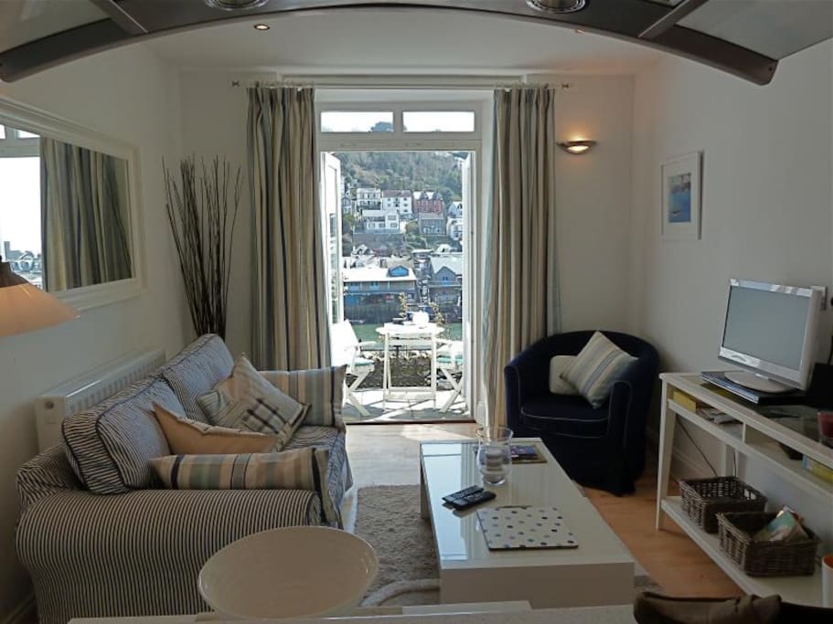Lounge looking out through patio doors over looe harbour