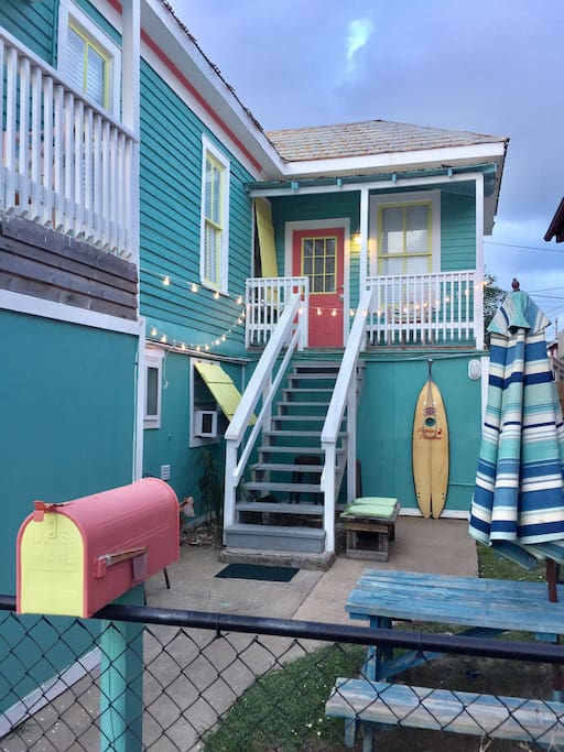 Entry gate leading to fenced yard and front door. Outdoor shower for guests use. Perfect for rinsing off after the beach!