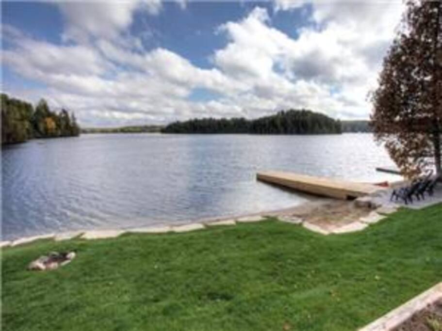 Lots of flat green space for everyone. Fire pit is conveniently placed by the water's edge.