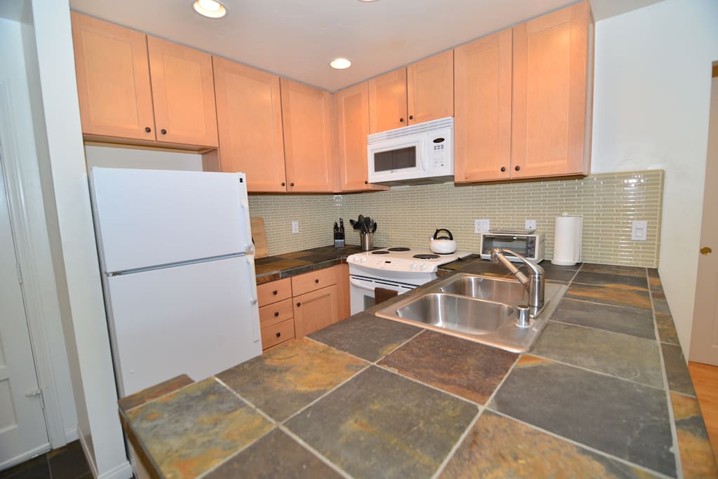 Fully stocked, updated kitchen with refrigerator, stove, oven, microwave, dishwasher, coffee maker, Keurig, spices, pots and pans, cookware, silverware, serving dishes and more!
