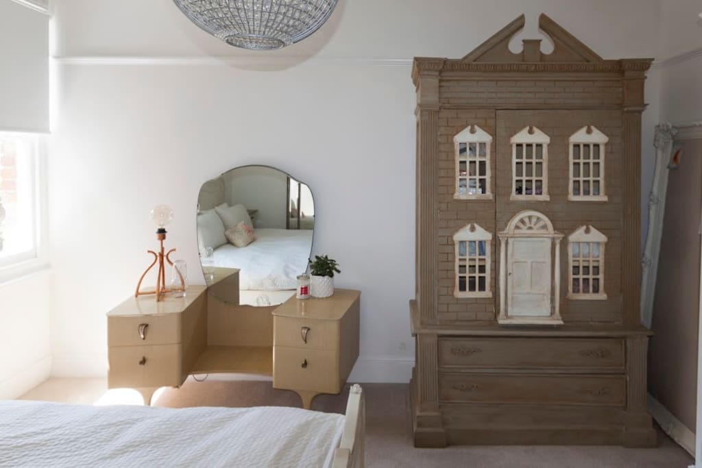 Feature dolls house wardrobe.