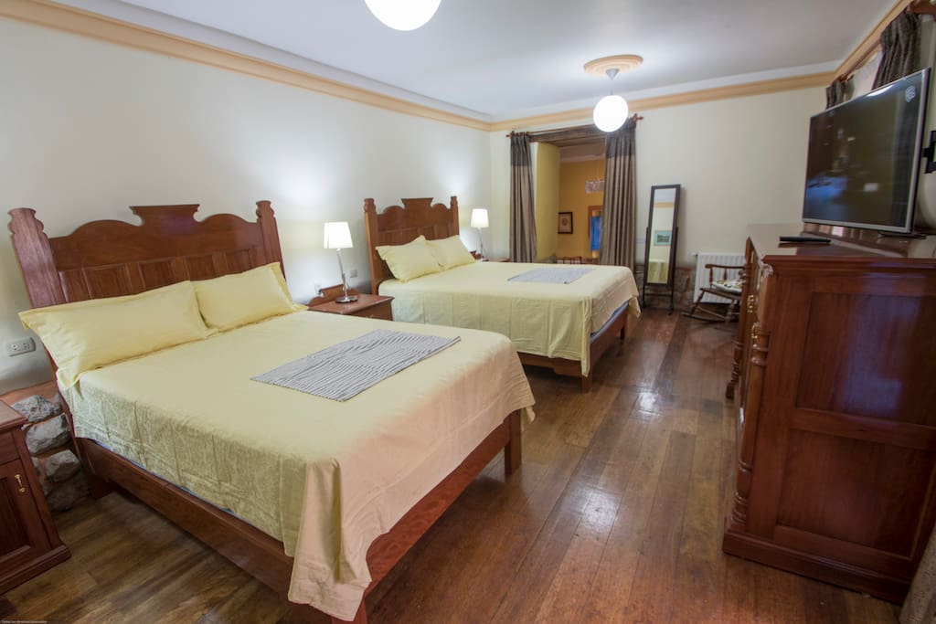 Spacious bedroom with queen and double bed.