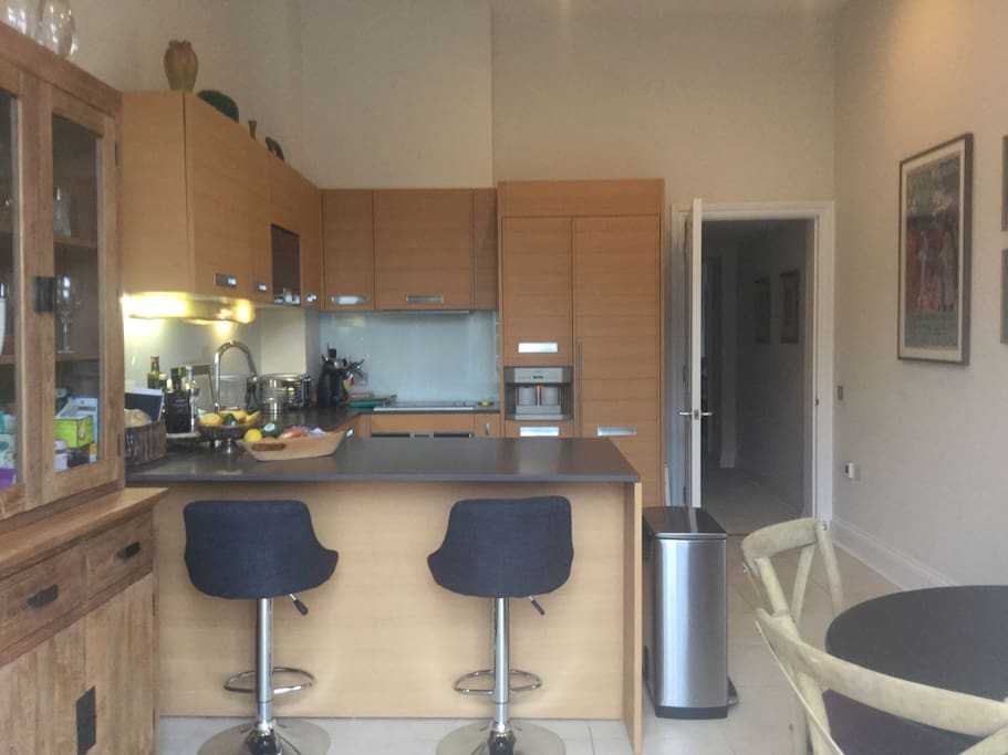 Kitchen with a large counter as well as breakfast table with 4 chairs.