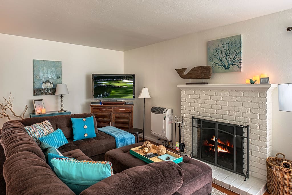The comfortable living room with flat screen tv and fireplace.