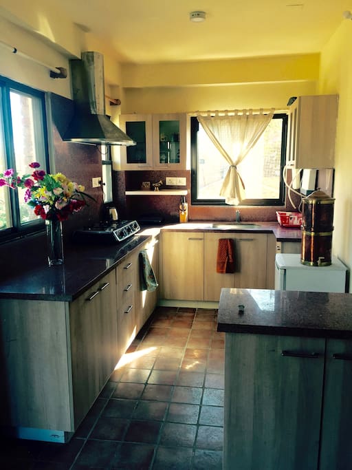 A bright and sunny fully-equipped kitchen.