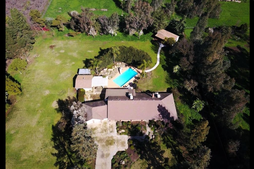 This is the 2.5 acres of property. The guest house is the small building in the back at the end of the concrete walkway.