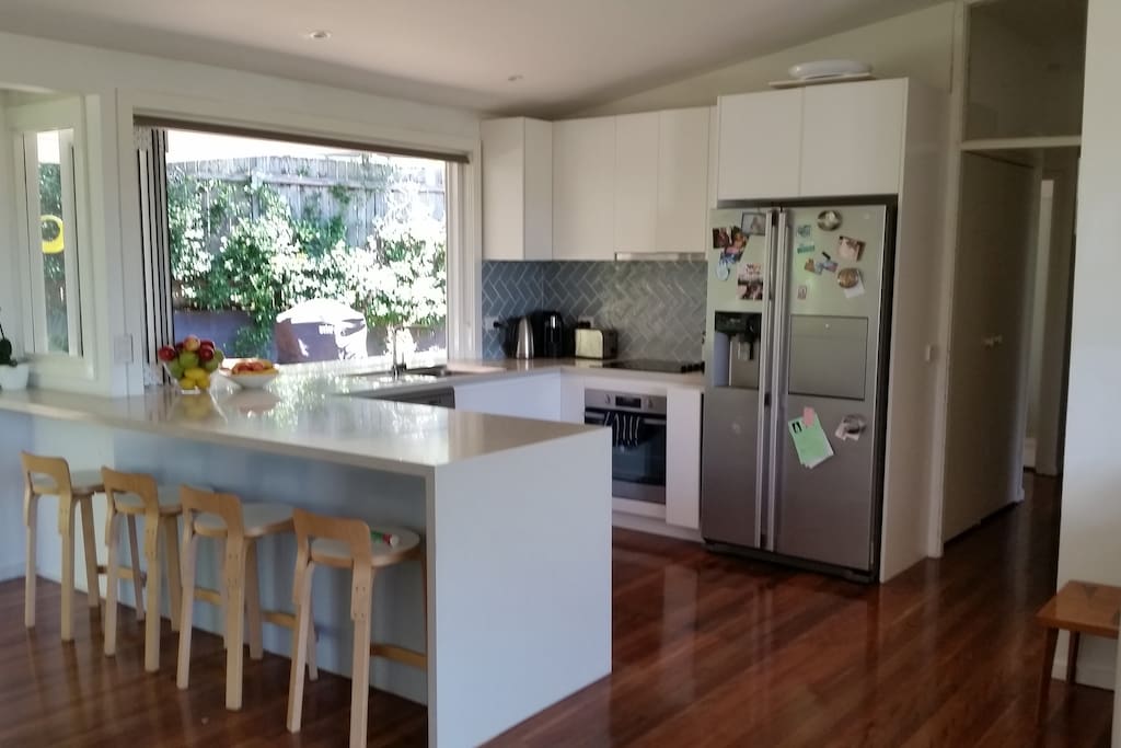 Kitchen, bifold windows open out to outside bench