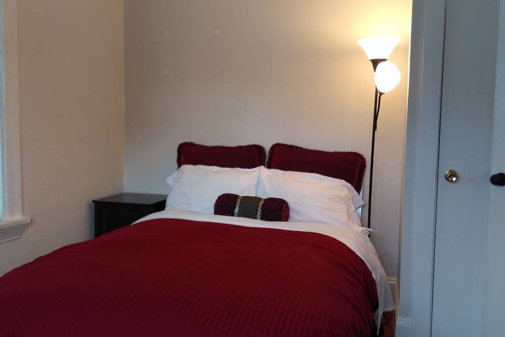 Full size bed in private room with closet, drawers, and desk space