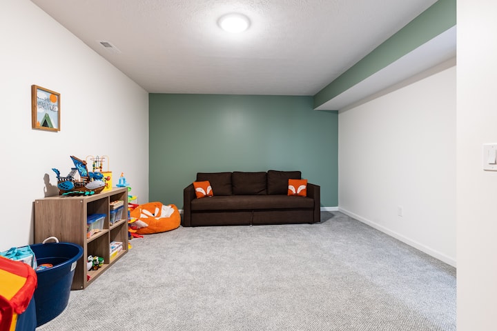 ¡La sala de juegos del nivel inferior es perfecta para que los niños la disfruten!  Hay juegos, libros y juguetes con los que jugar.  El sofá se convierte en una cama tamaño queen en caso de que necesites espacio adicional.