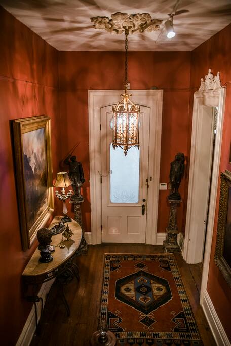 Foyer filled with sculpture and oil paintings