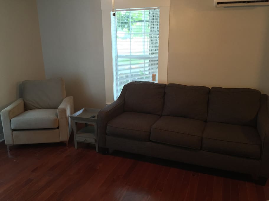 Sofa and chair in den area.