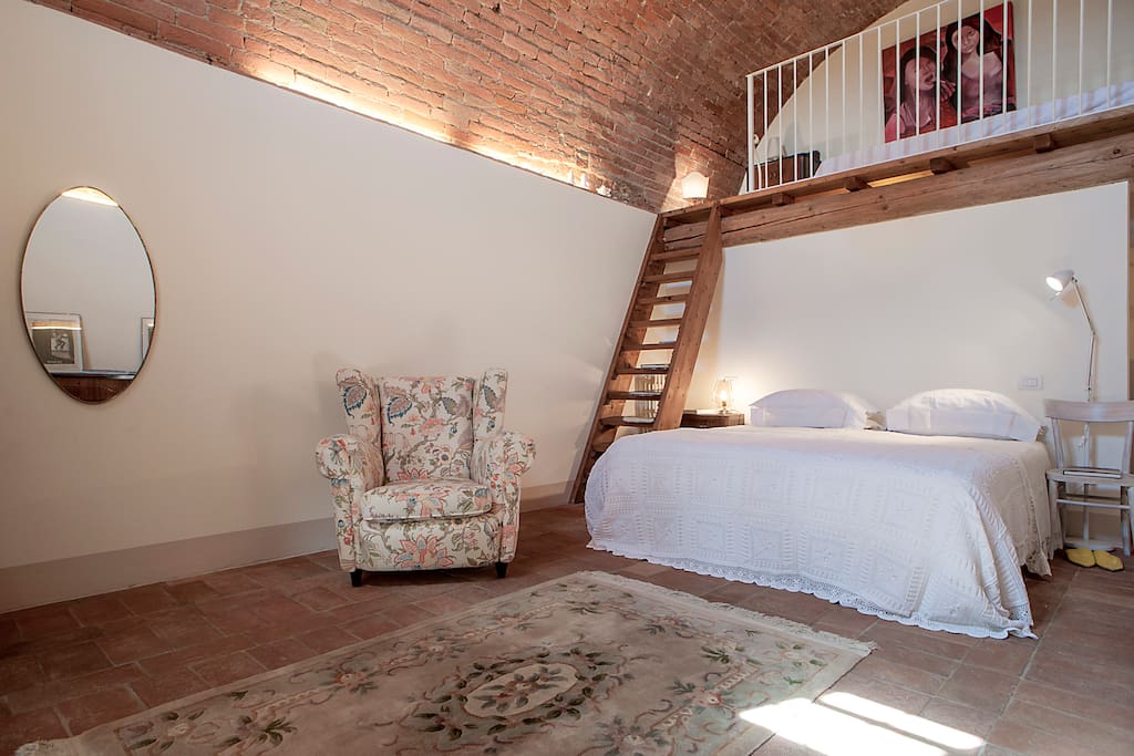 The bedroom is placed in an old winecellar