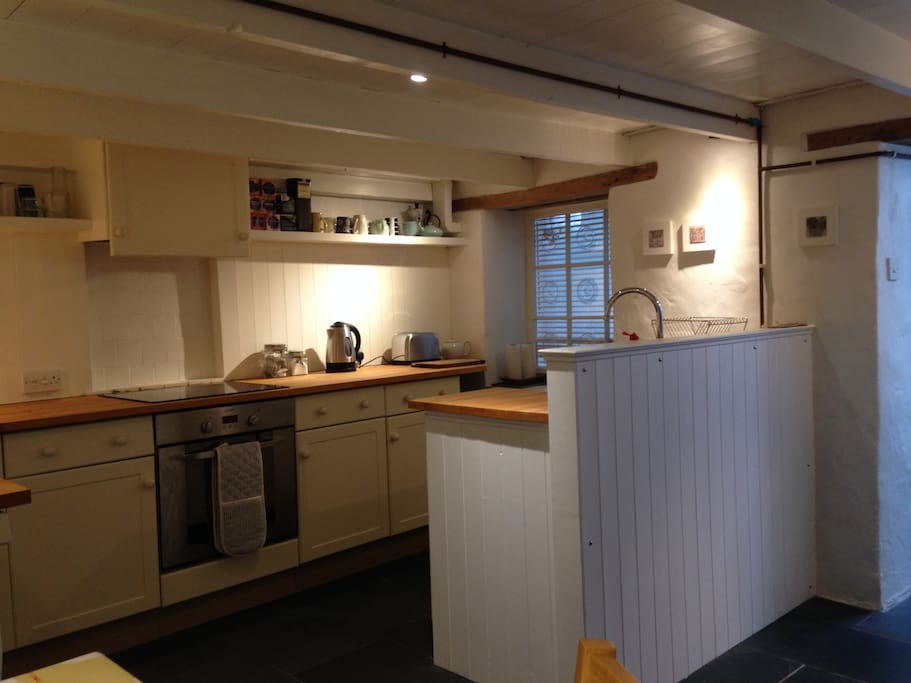 Kitchen with induction hob, belfast sink, integrated fridge, freezer and washing machine
