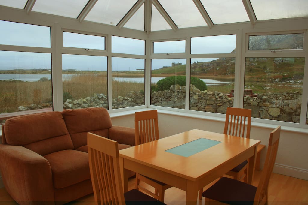 Conservatory with stunning views looking out over the lake at the foot of Doon Hill.