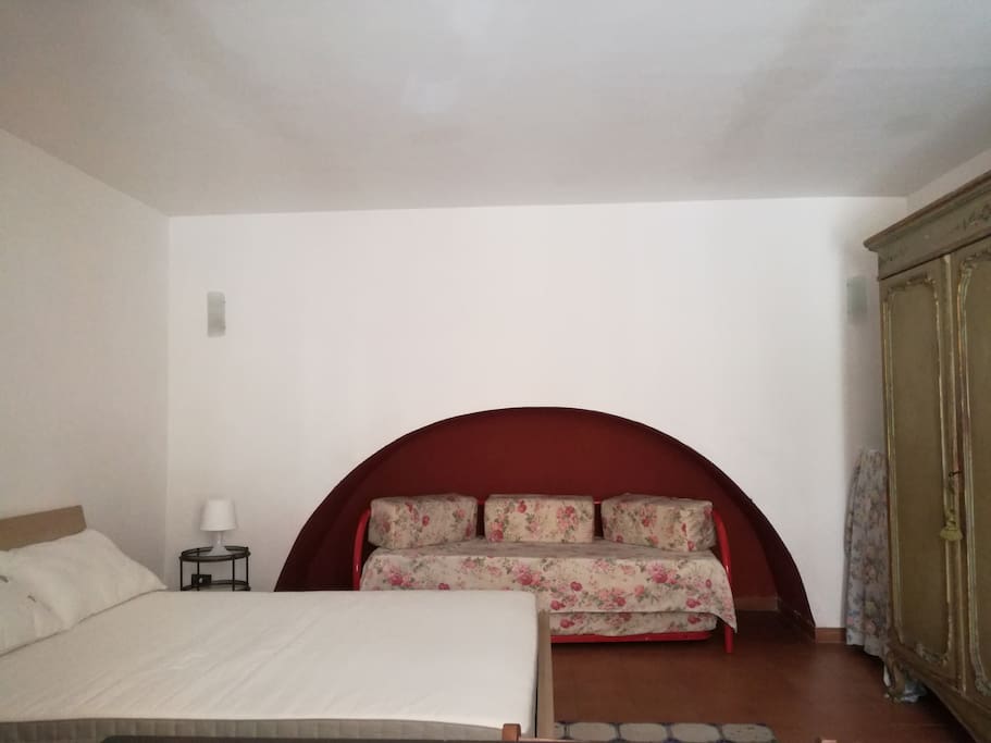 The bedroom with double bed and single bed
