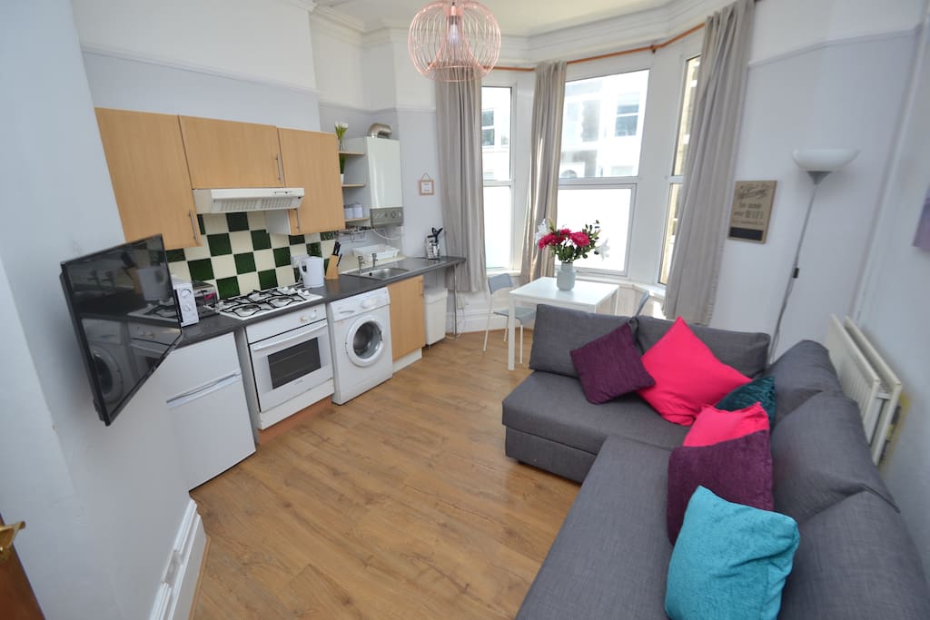 Open plan living space with table and TV