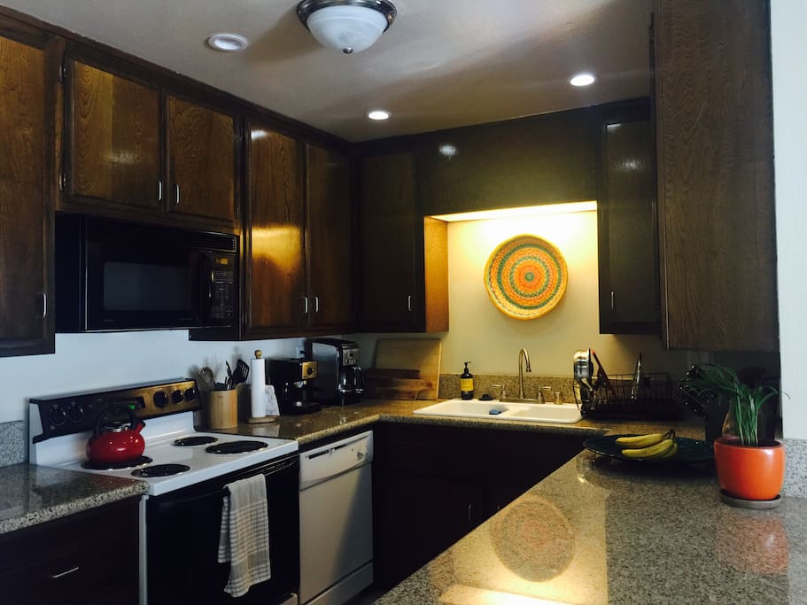 Open kitchen with dishwasher, stove, microwave and all the kitchen supplies and spices you need to cook a fabulous dinner!