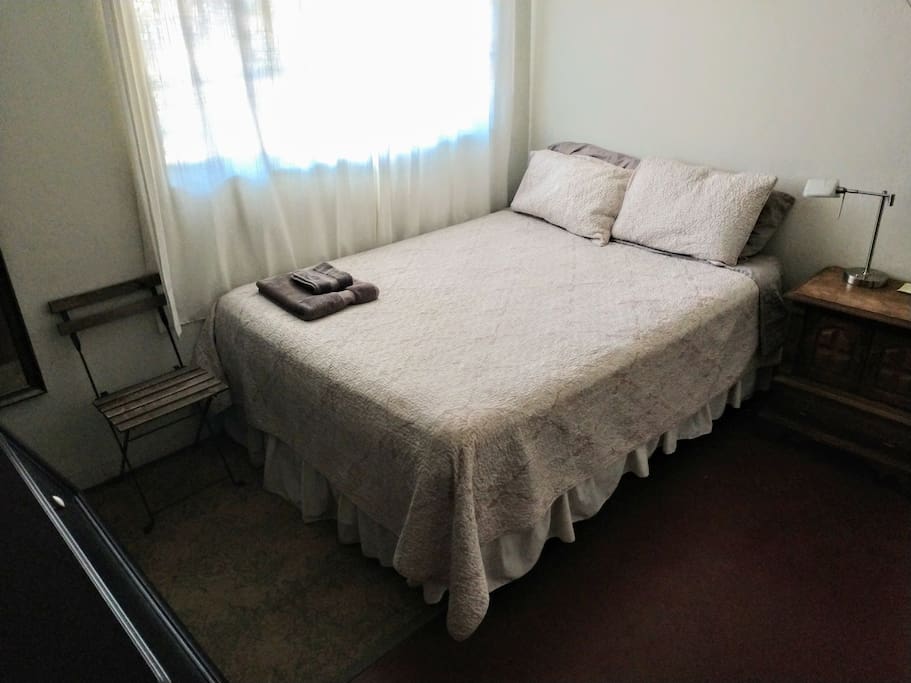 Your bedroom! Queen size bed and window into the back yard