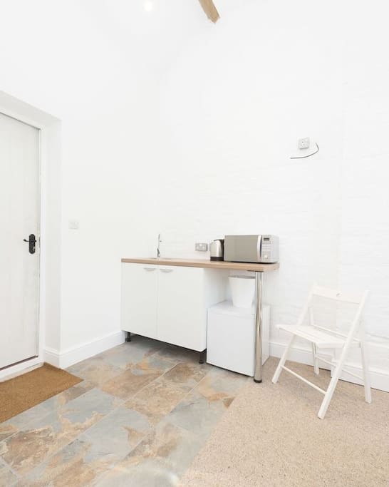 Complete kitchenette, with microwave, fridge, crockery, cutlery etc