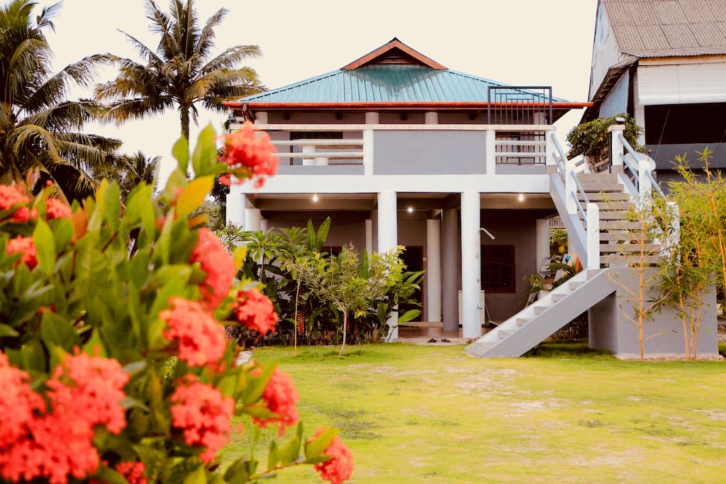 House and garden from outside. All four guest rooms are upstairs.