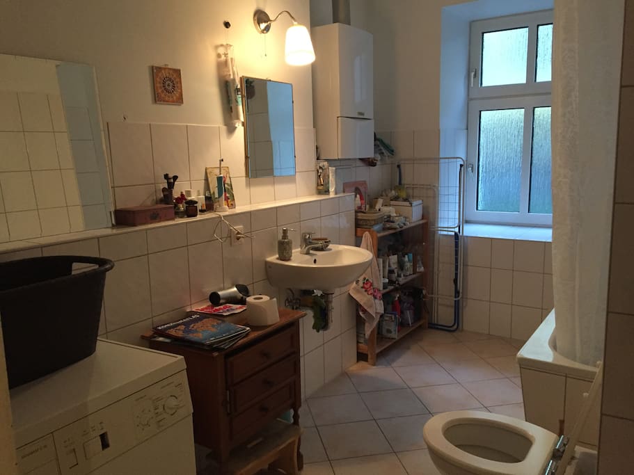 big bathroom with bathtube and washingmashine