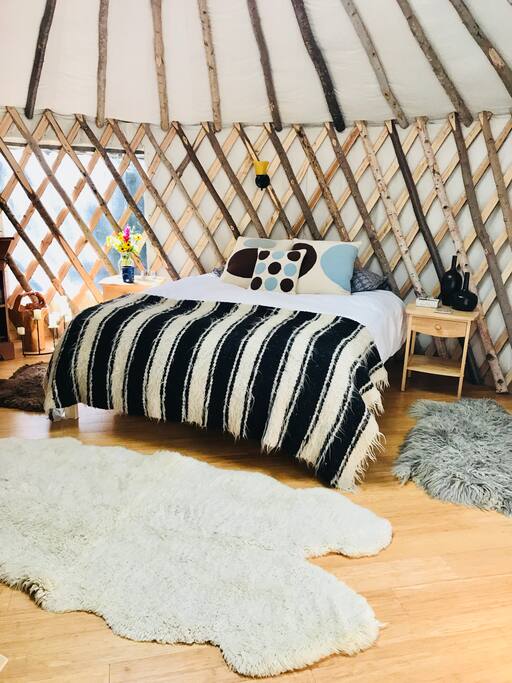 Queen size bed with cozy Down Comforter and Pillows.