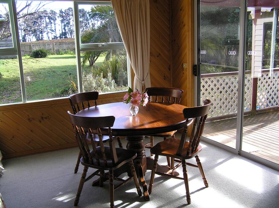 Dining area and view to large fenced backyard and outdoor patio