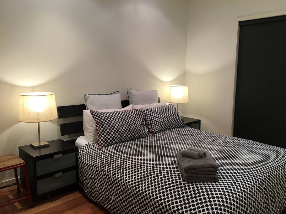 Master bedroom with window into the courtyard and a robe to place your things.