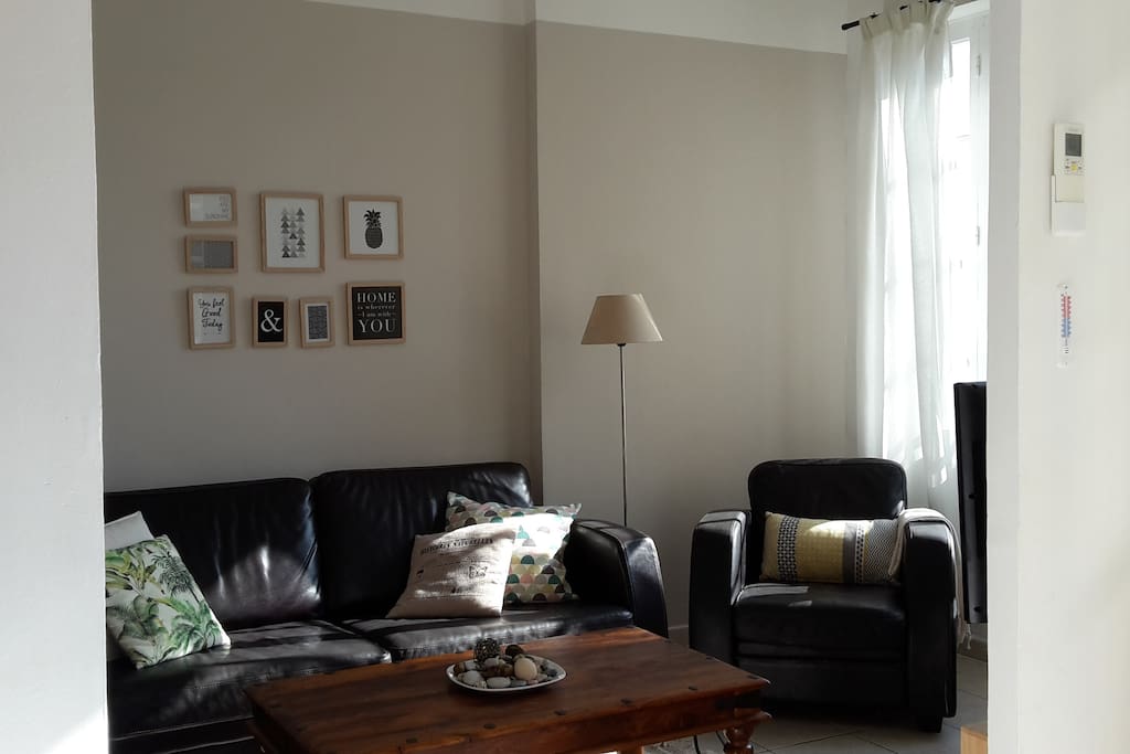 Living room with sofa, armchair, sofa table, tv and stereo