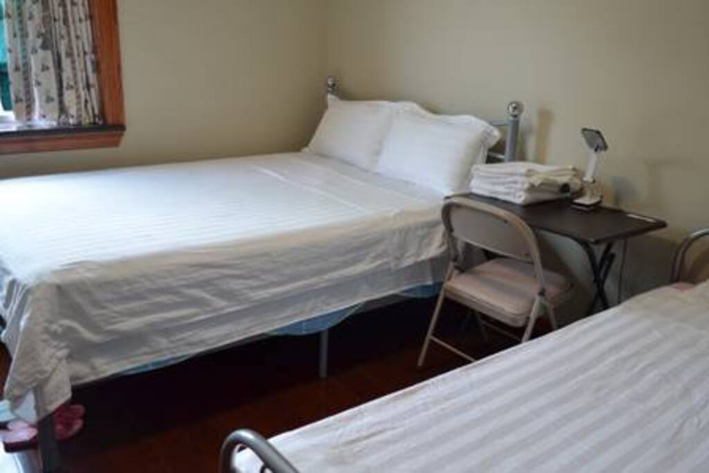 new queen bed & single bed for three guests accommodates