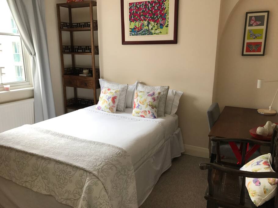 Double bedroom with sash window and workspace