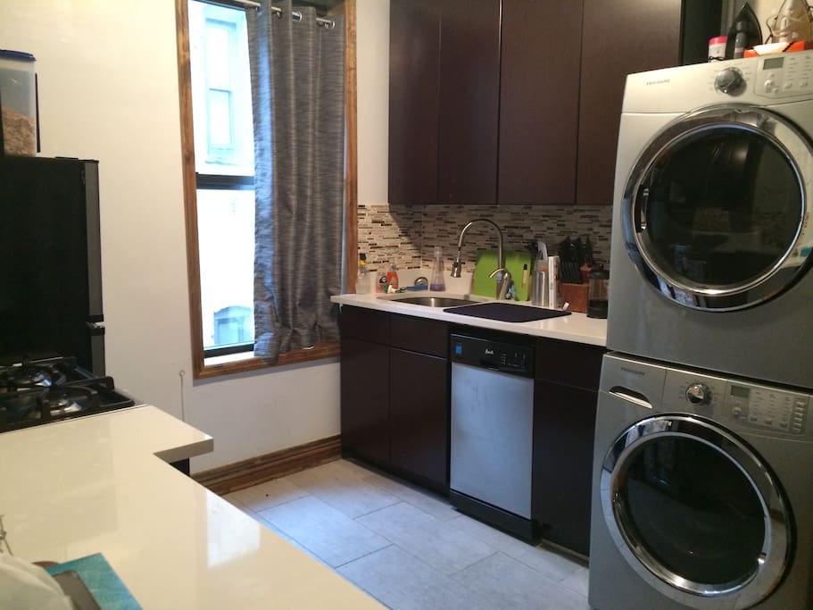 Fully furnished kitchen with washer and dryer set.
