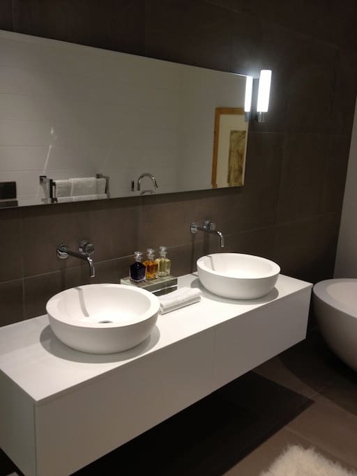 Private ensuite bathroom with dual sink and high end bath products.