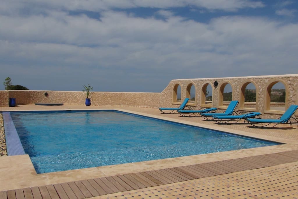 View of pool with loungers and Jacuzzi spa cover. Jacuzzi features underwater lighting feature and sound and lots of different massage jets and bubbles!