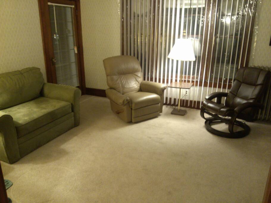 Loveseat and two reclining chairs next to the TV