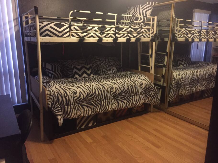 Animal print theme room. Two twin beds with comfy linen.