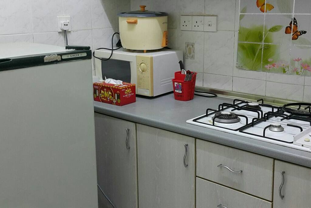 Kitchen with rice cooker, microwave, fridge