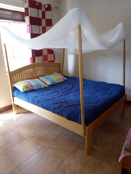 The bed, with a treated mosquito net.
