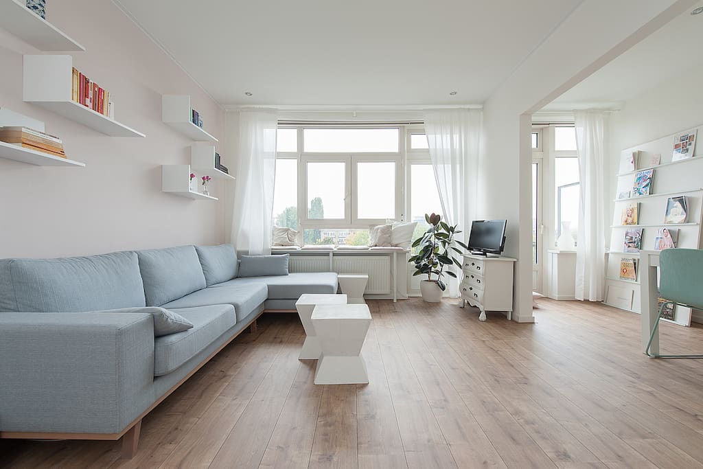 Living room with big sofa and seats in the window to enjoy the view