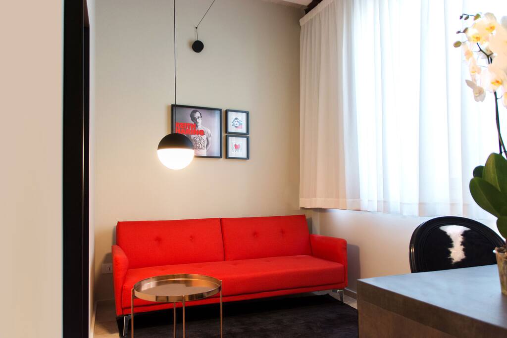 Al suo ingresso una spaziosa camera da letto caratterizzata da colori tenui in pendant con il resto degli arredi e da dettagli colorati. Alla sinistra armadio a vista disegnato e progettato su misura esclusivamente per CinqueSuites. Ampio bagno con elementi matt black che fanno da contrasto alle venature del legno che regge il lavabo dalle forme decise ma eleganti e alla parete doccia rivestita interamente in Corten. Il soggiorno dal suo magico red passion style, in cui la speciale lampada String Light di Flos crea il suo gioco di fili da una parete all’altra. Con balconcino che si affaccia sul suggestivo Ronco Purgatorio. L’intera struttura è pavimentata con tradizionale pietra di Modica siciliana.