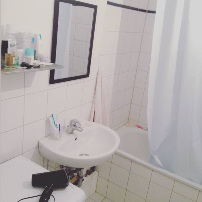 Bathroom with tub and washing machine