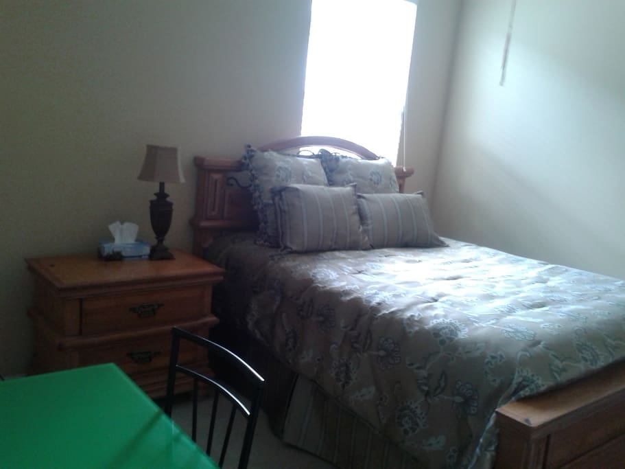 Bedroom 1 has a queen size bed with a work station and closet space.