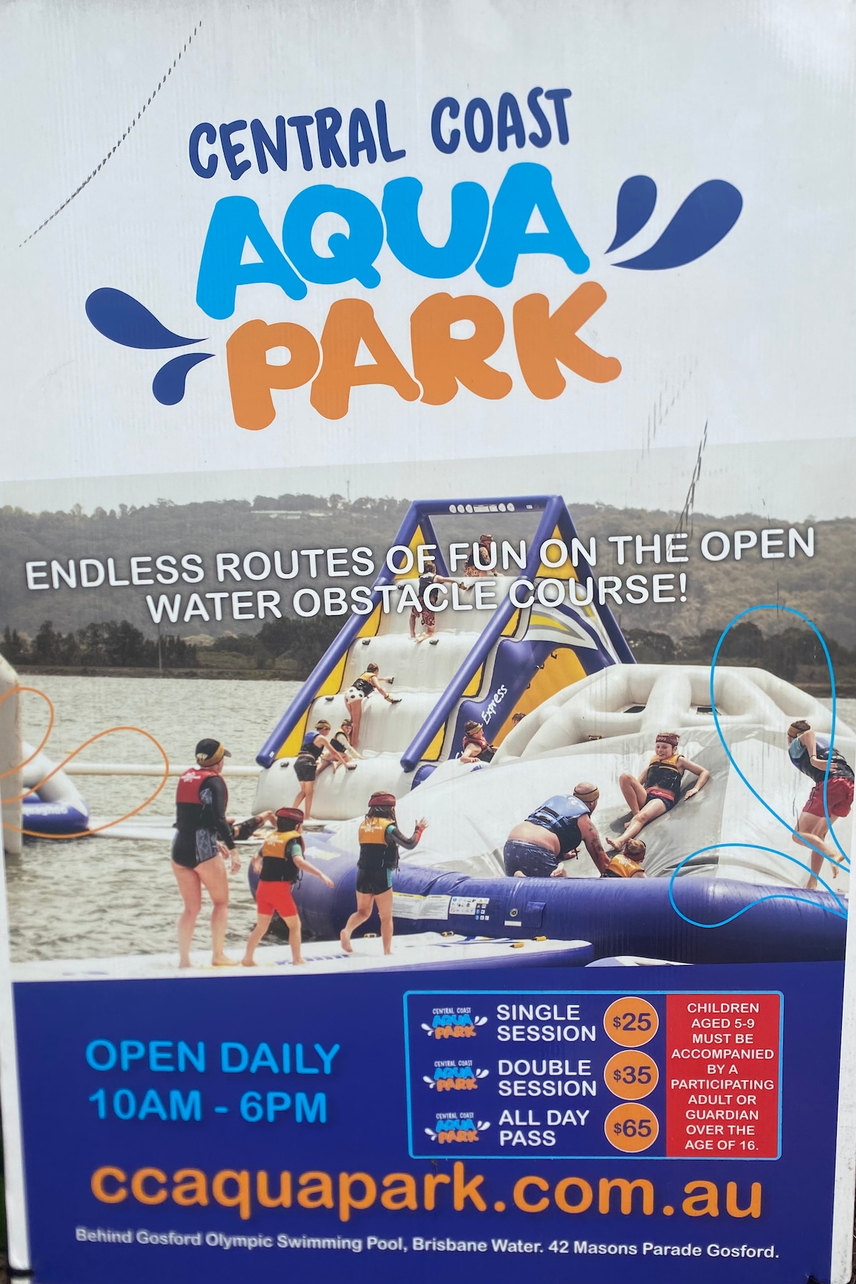 A promotional poster for Central Coast Aqua Park displays an inviting open water obstacle course. Bright colors accentuate the image, featuring individuals engaging in various water activities. Operational hours are noted, along with pricing details for single and double sessions, and an all-day pass option.