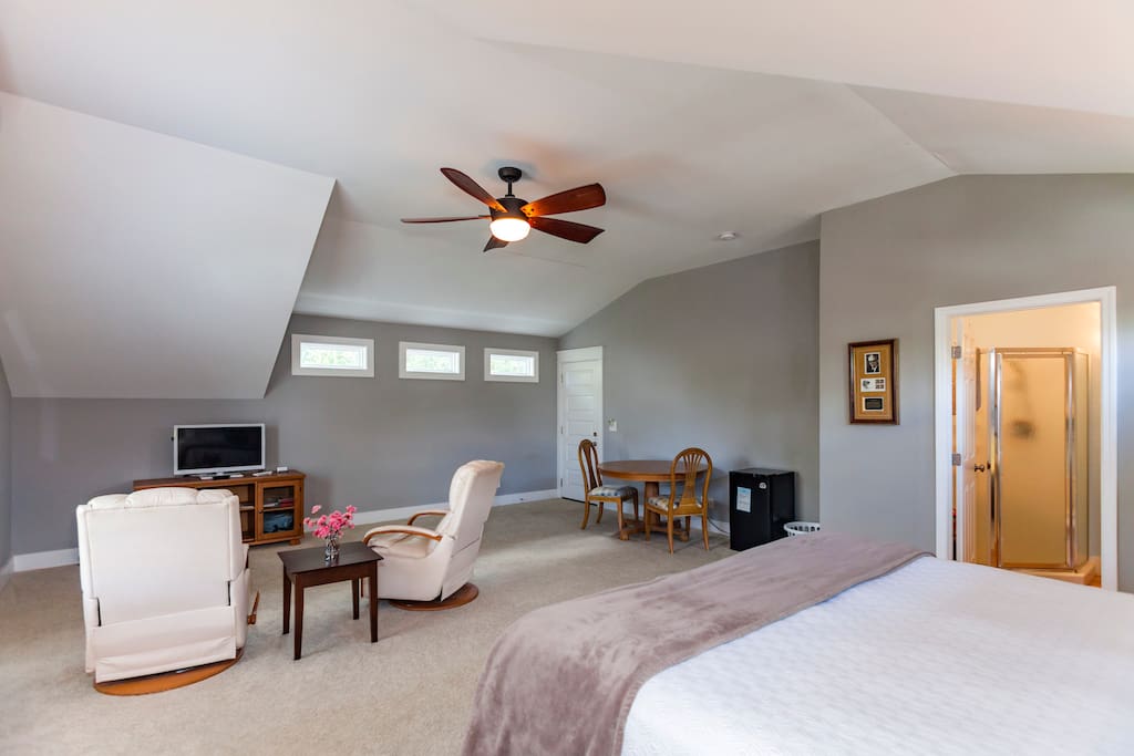 Bed (king sized, great mattress) in foreground with sitting area