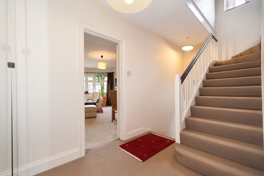 Split level staircase leading to upstairs bedroom and bathroom