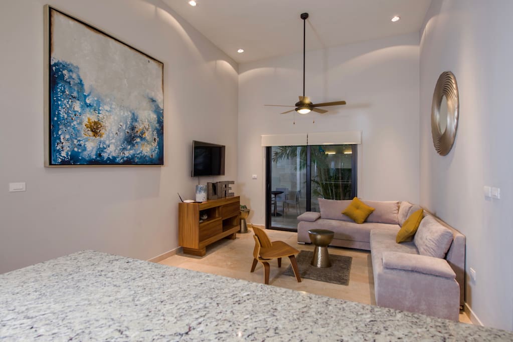 Living room has flat screen TV, comfortable sofa bed for one